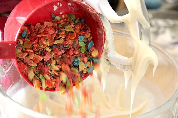 Fruity Pebbles being added to white chocolate fudge batter