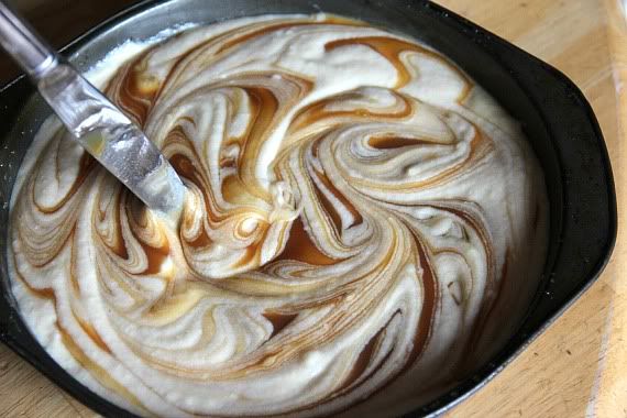 Caramel sauced swirled into vanilla cake batter in a pan