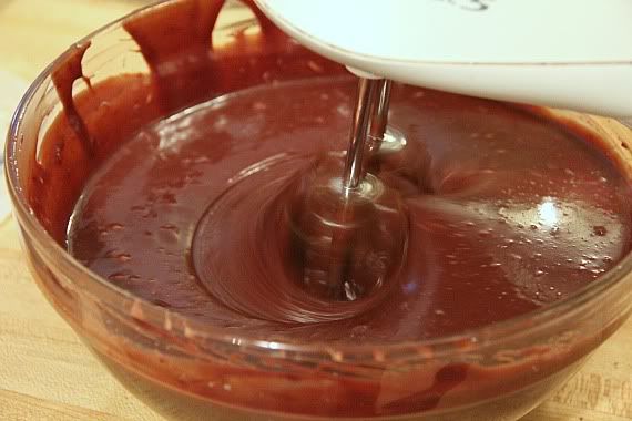 Chocolate batter in a bowl with a hand mixer