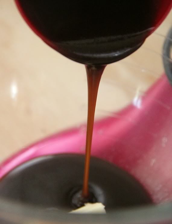 Caramel sauce being poured into a mixing bowl