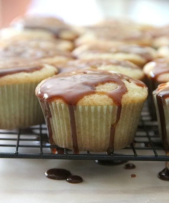 Vanilla cupcakes with caramel drizzle on a cooling rack