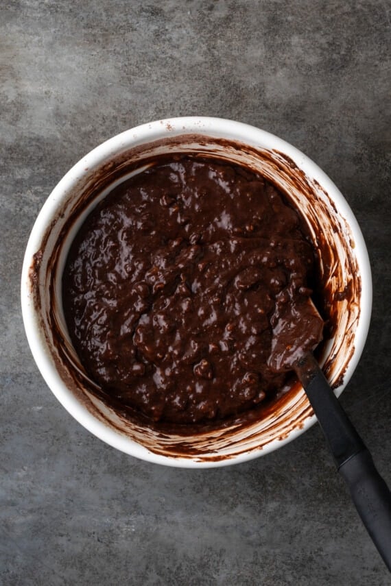 Banana bread brownie batter in a mixing bowl with a spoon.