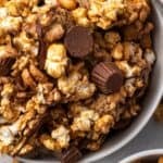Overhead view of peanut butter popcorn in a white bowl.