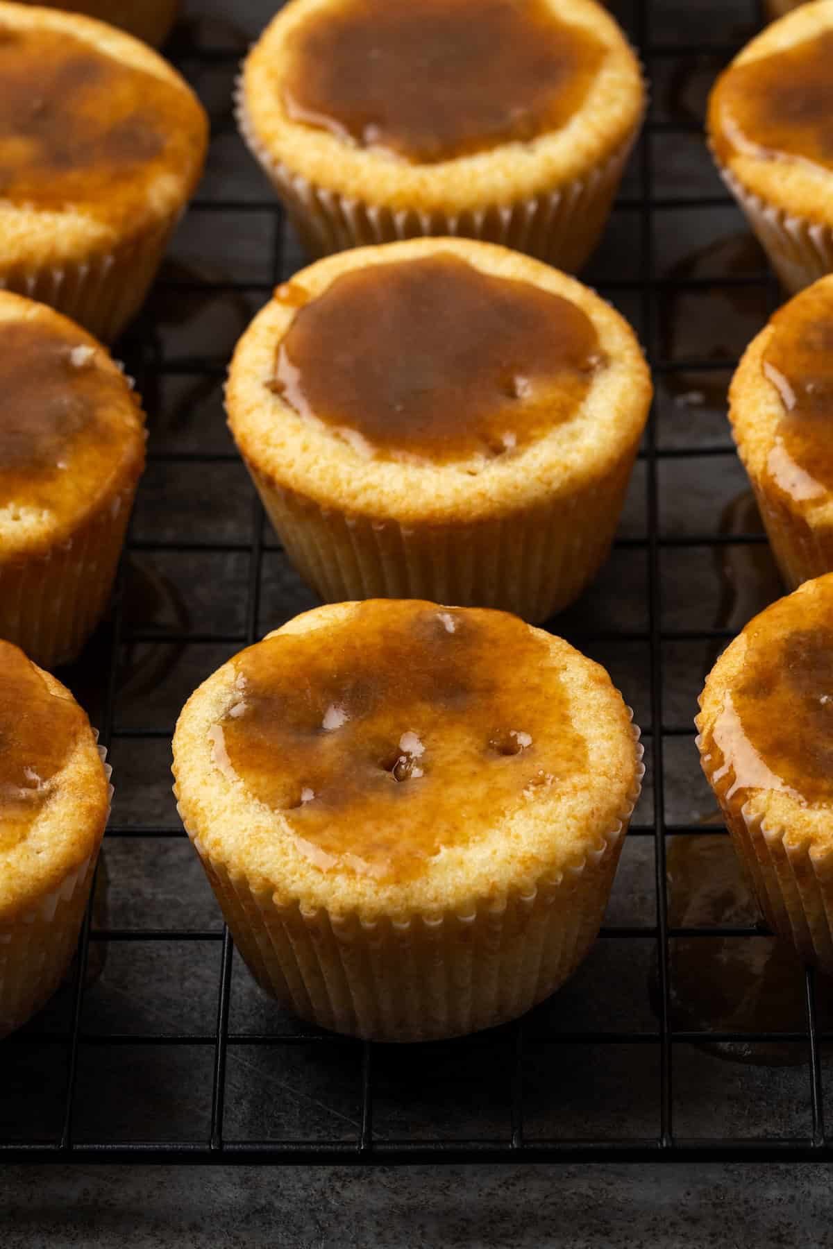 Baked cupcakes topped with caramel sauce.