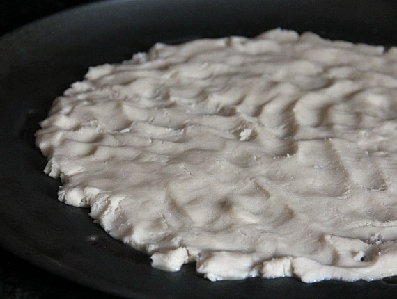 Sugar cookie dough pressed into a round pizza pan