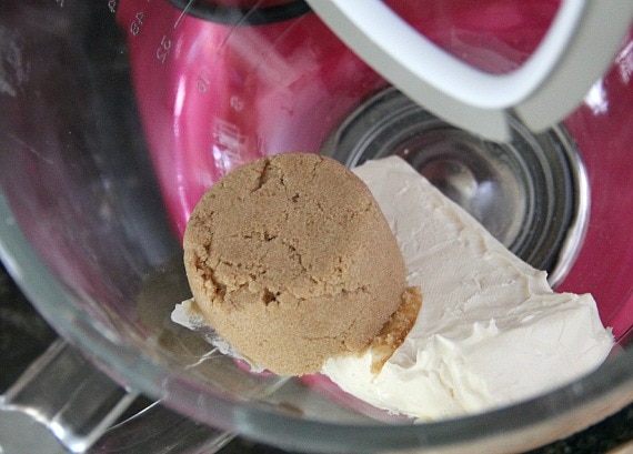 Top view of cream cheese and brown sugar in a stand mixer bowl