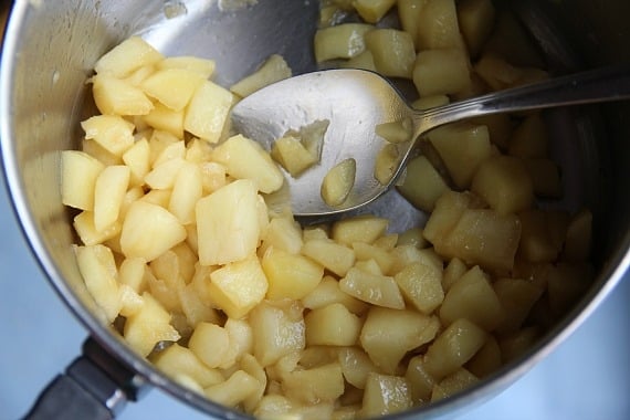 Peeled diced apples cooking in a pan