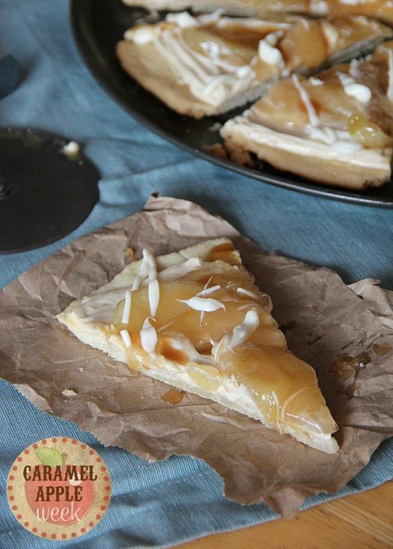 A slice of caramel apple pizza on a piece of brown paper