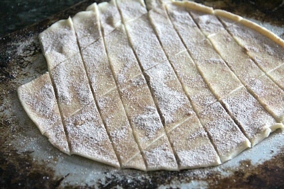 Cinnamon sugar topped pie crust dough cut into a grid of pieces