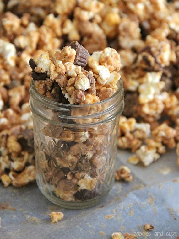 Peanut butter cup popcorn in and around a small jar