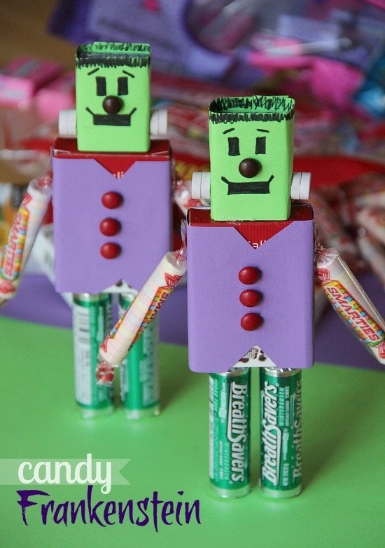 Two candy frankensteins standing up on a green surface