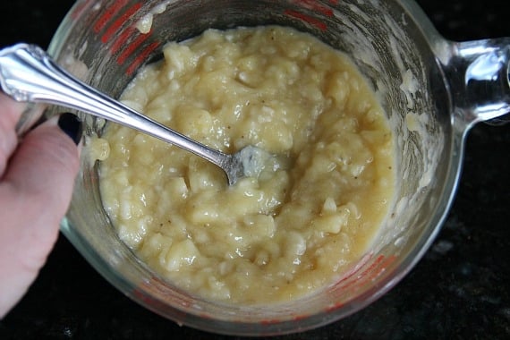 Top view of mashed bananas in a glass liquid measuring cup
