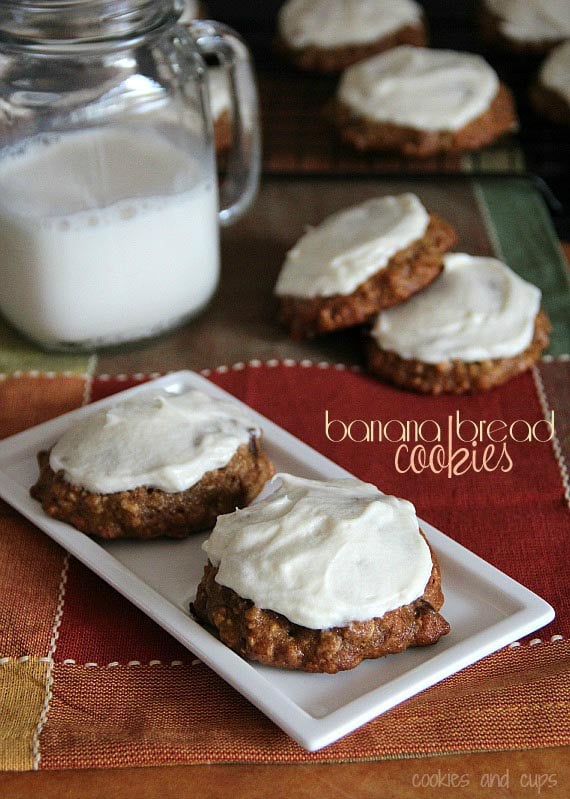 Overhead view of banana bread cookies with maple cream cheese frosting on a plate