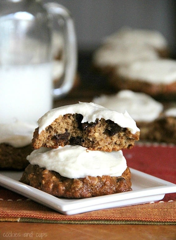 Two banana bread cookies with white frosting on a plate