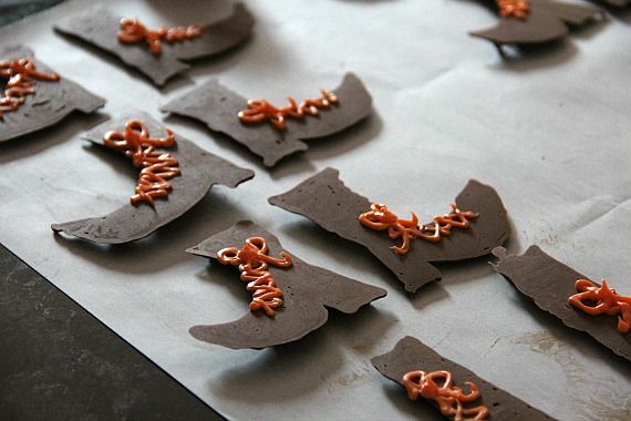 Chocolate witch boots with orange laces on parchment paper