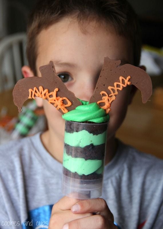 A child holding a witch push-up pop