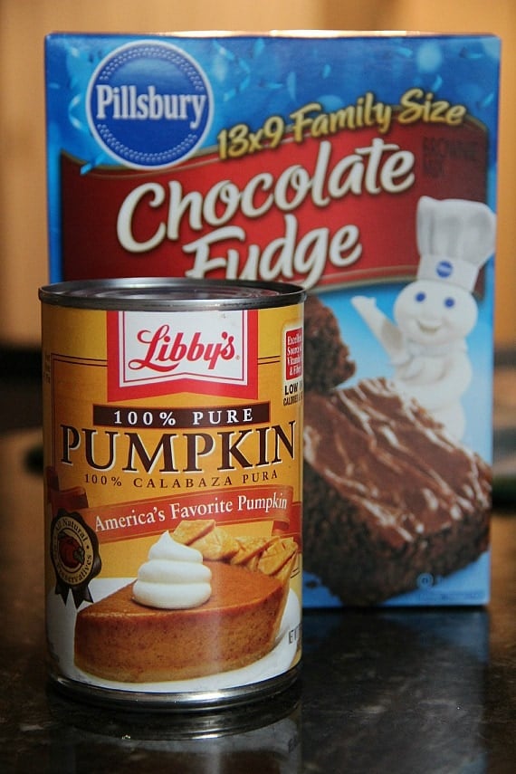 A can of pumpkin puree next to a box of chocolate brownie mix.