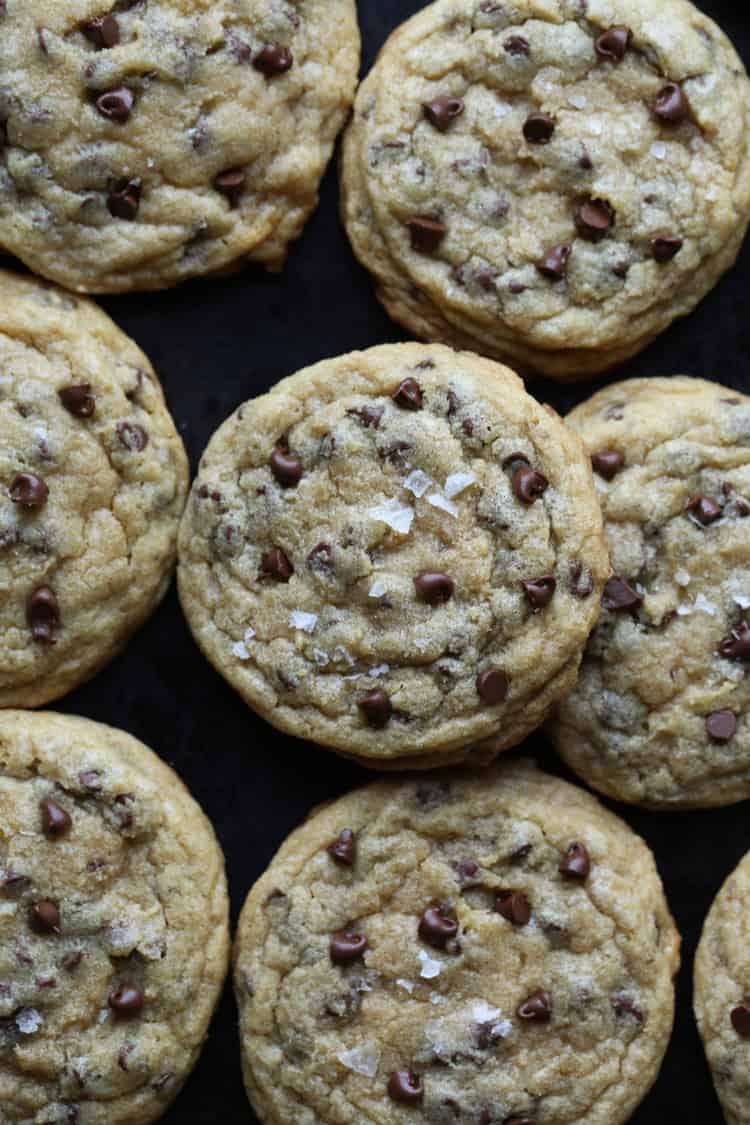 Chocolate chip cookies on a dark surface.