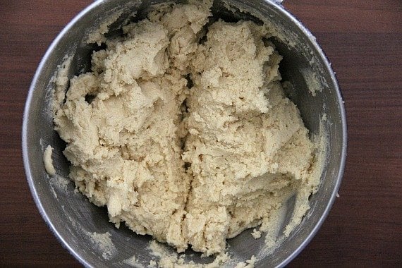 Top view of dough split in half in a mixing bowl