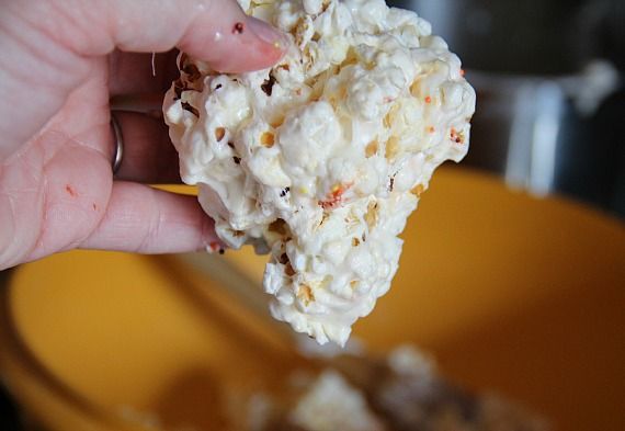 Popcorn marshmallow mixture being formed into a ball