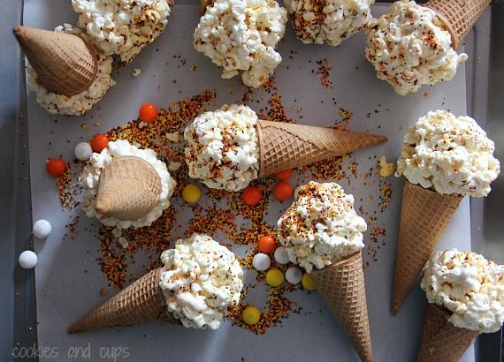 Popcorn ball ice cream cones laying on a sheet of parchment