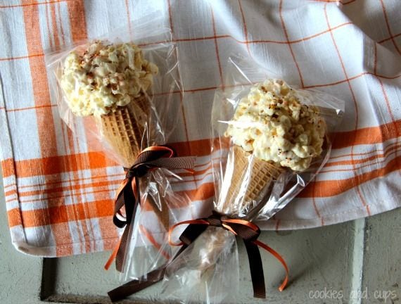 Two popcorn ball ice cream cones packaged in plastic with a ribbon