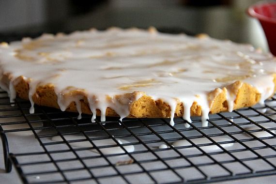 Glazed round pumpkin shortbread on a cooling rack