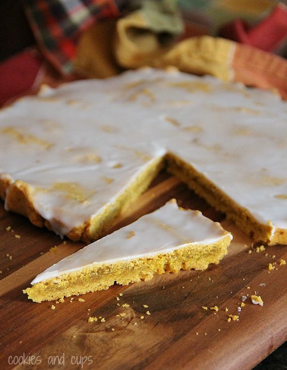 A round glazed pumpkin shortbread with a wedge cut out