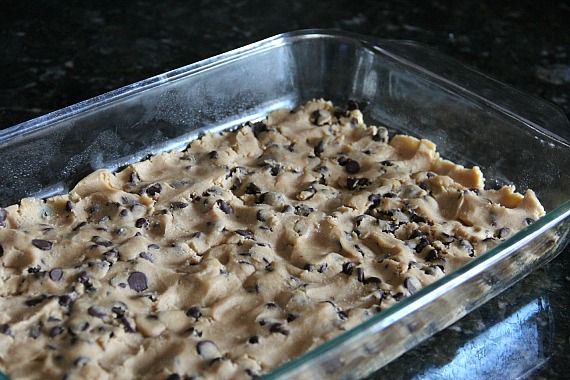 Chocolate chip cookie dough pressed into a 9x13 pan