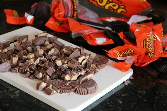 Chopped Reeses peanut butter cups on a cutting board