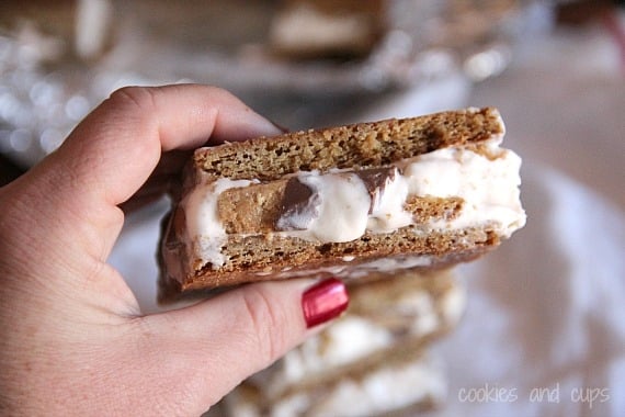 A hand holding a stacked blondie ice cream sandwich