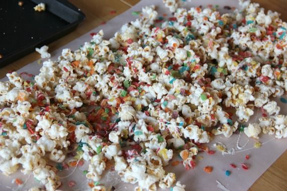 Fruity Pebbles kettle corn on a sheet of parchment paper