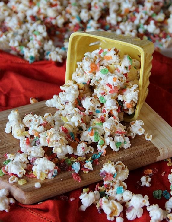 Fruity Pebbles kettle corn spilling out of a yellow carton