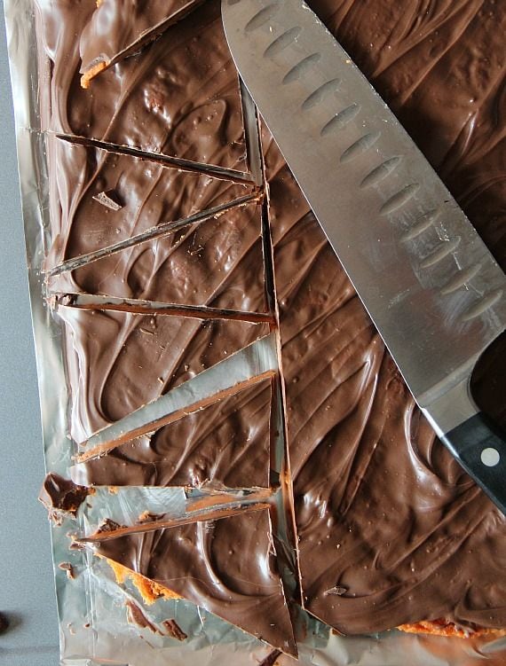 A pan of butterfinger bark cut into triangular pieces