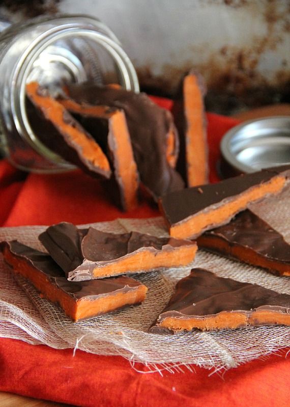 Pieces of homemade butterfinger bark spilling out of a jar