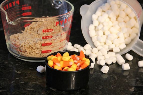 A bowl of chex cereal, candy corn, and mini marshmallows