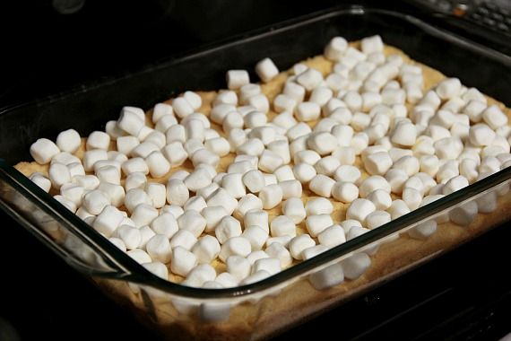 Mini marshmallows spread over crust in a 9x13 pan