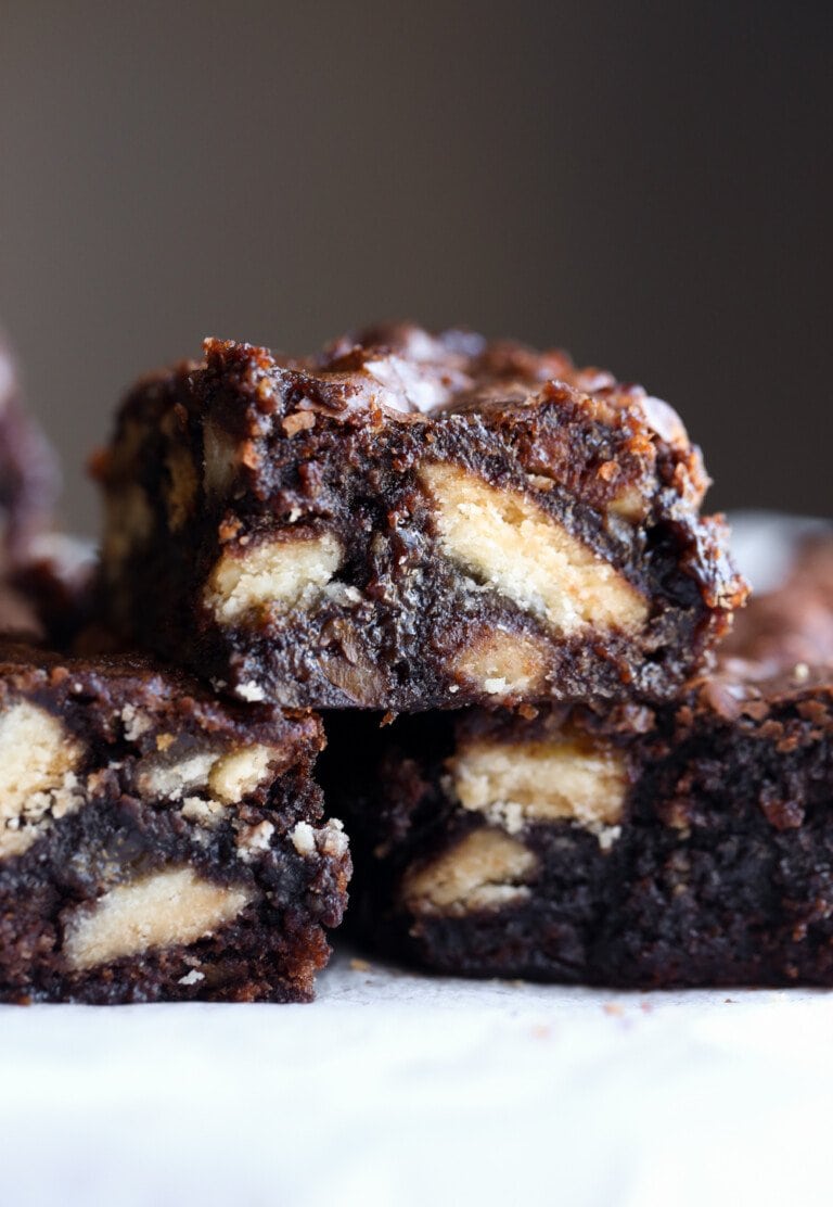 Pecan pie brownies stacked on parchment paper