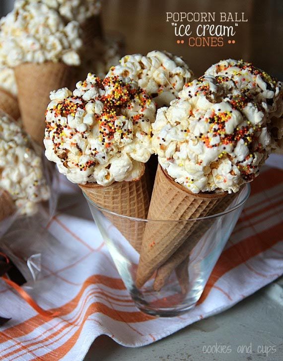 Several popcorn ball ice cream cones standing in a dish