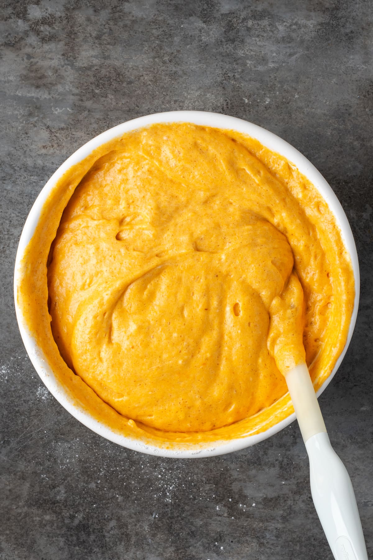 Pumpkin bar batter in a metal mixing bowl.