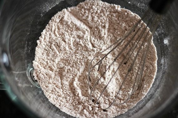 Top view of dry cupcake ingredients in a bowl with a whisk