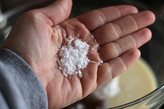 Sea salt flakes on the palm of a hand