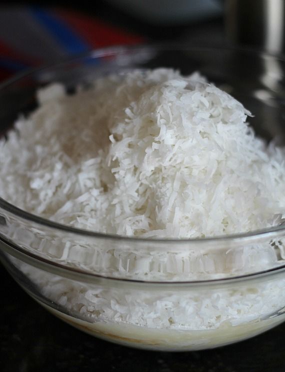 A big heap of shredded coconut in a mixing bowl