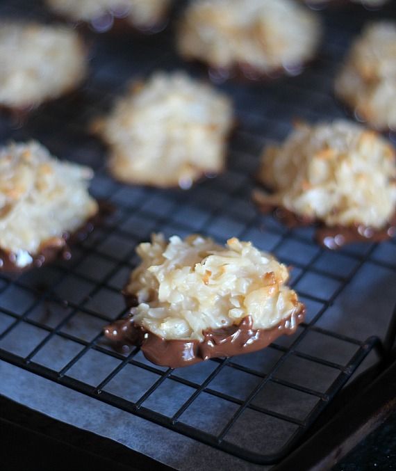 Chocolate dipped coconut macaroons on a cooling rack