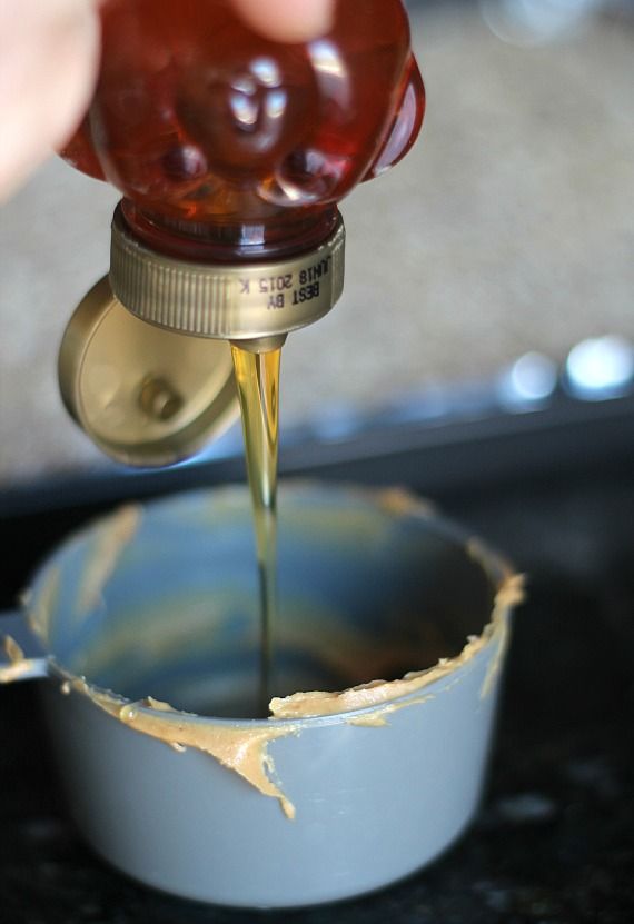 Honey being poured into a measuring cup