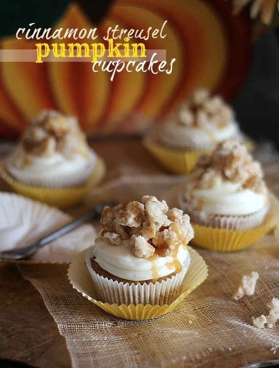 Several pumpkin cupcakes with cinnamon streusel on a burlap cloth