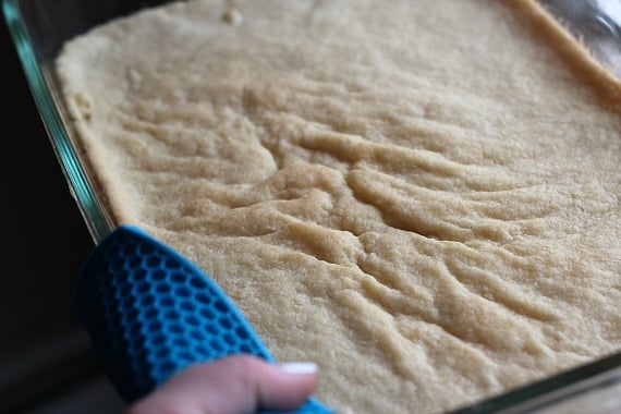 Baked cheesecake crust in a rectangular pan