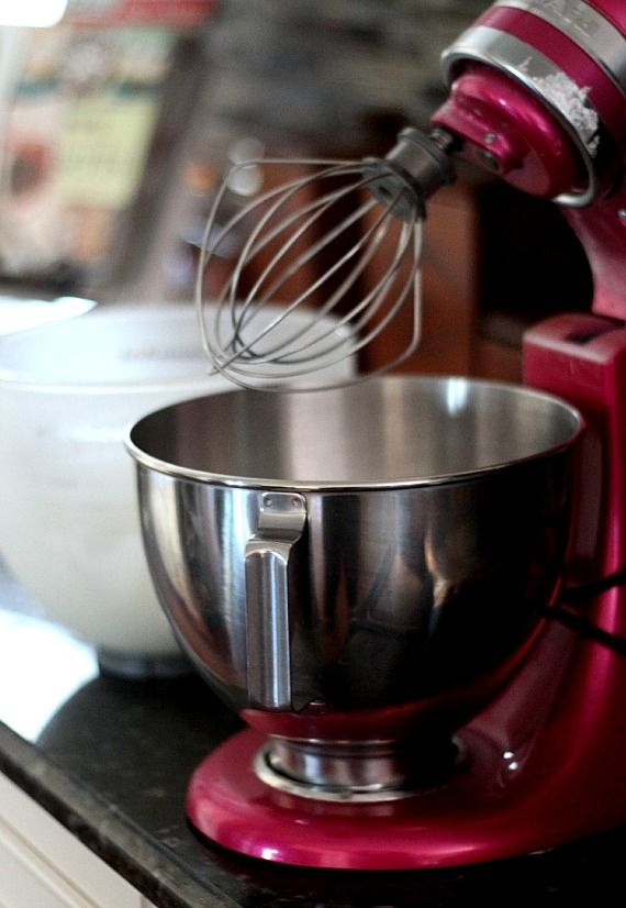 Red KitchenAid stand mixer with whisk attachment