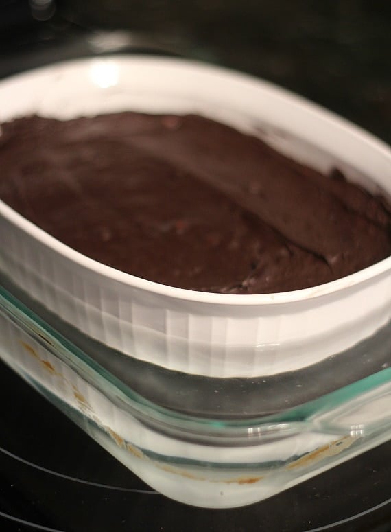 Chocolate batter in a baking dish inside a larger baking dish filled with water
