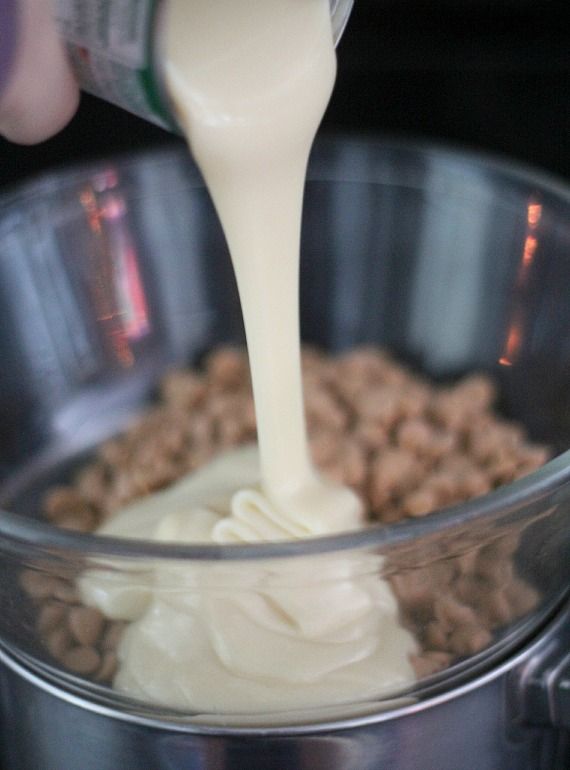 Peanut butter chips and sweetened condensed milk in a double-boiler bowl